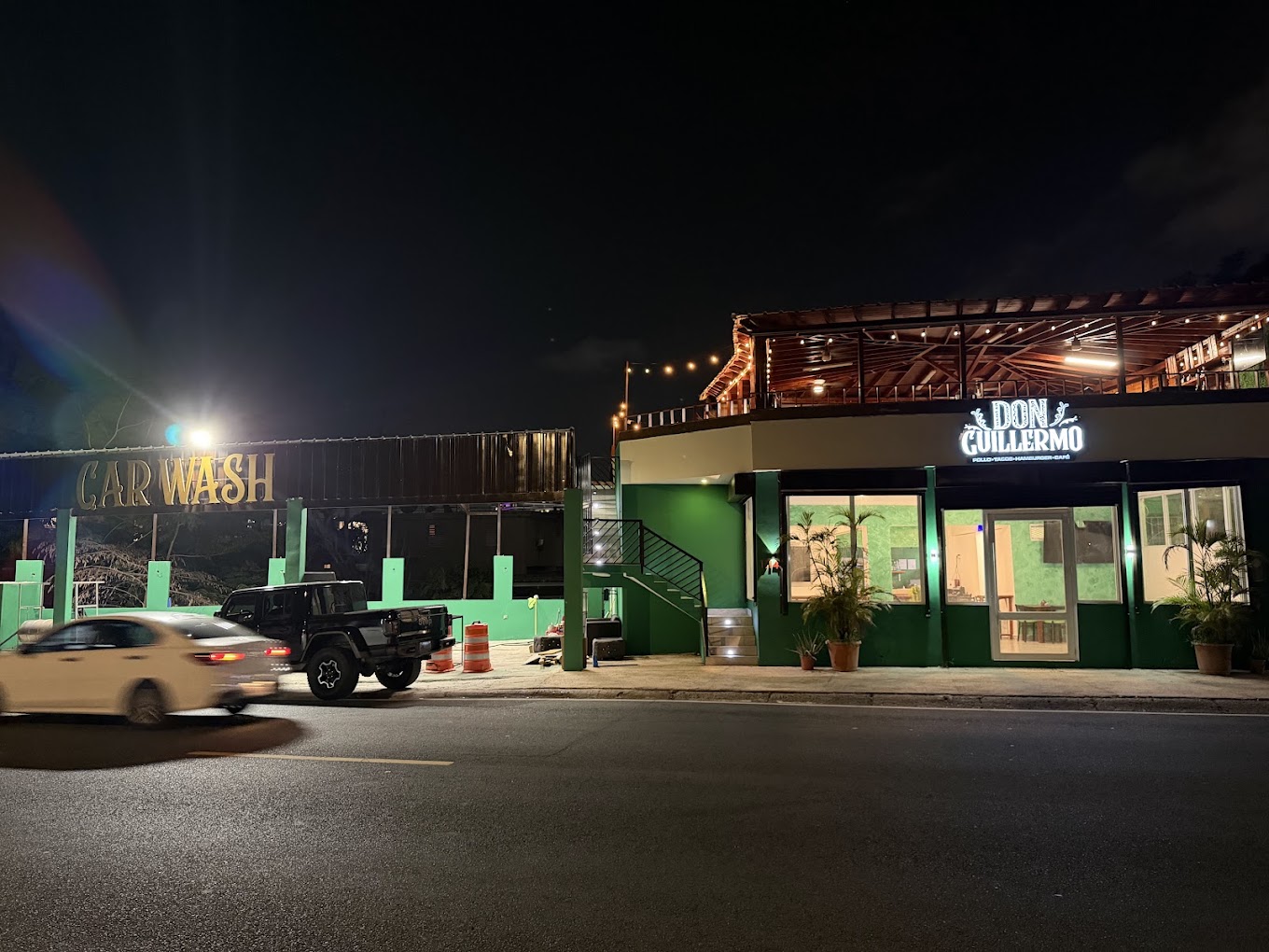Don Guillermo restaurant and adjoining car wash sign at night