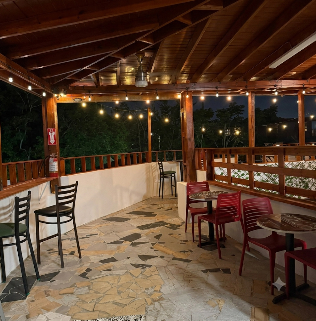 Terrace seating area with string lights at night